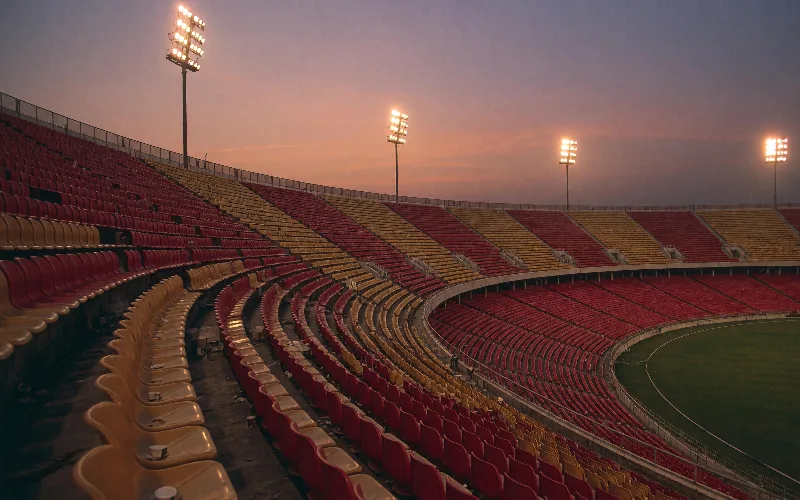 Cricket stadium at night with a packed stand